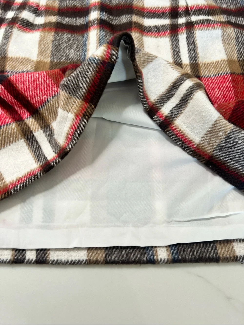 Plaid Mini Skirt in Red and Brown. Comes with size zipper. Size M